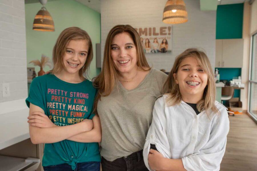 mom with her daughters after they received braces