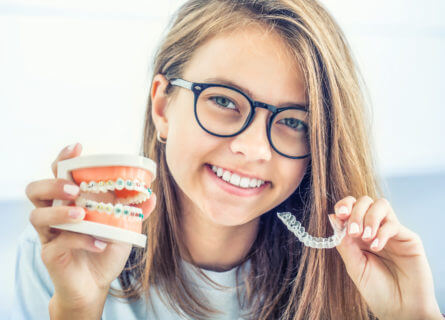 young girl smiling after her braces have been removed
